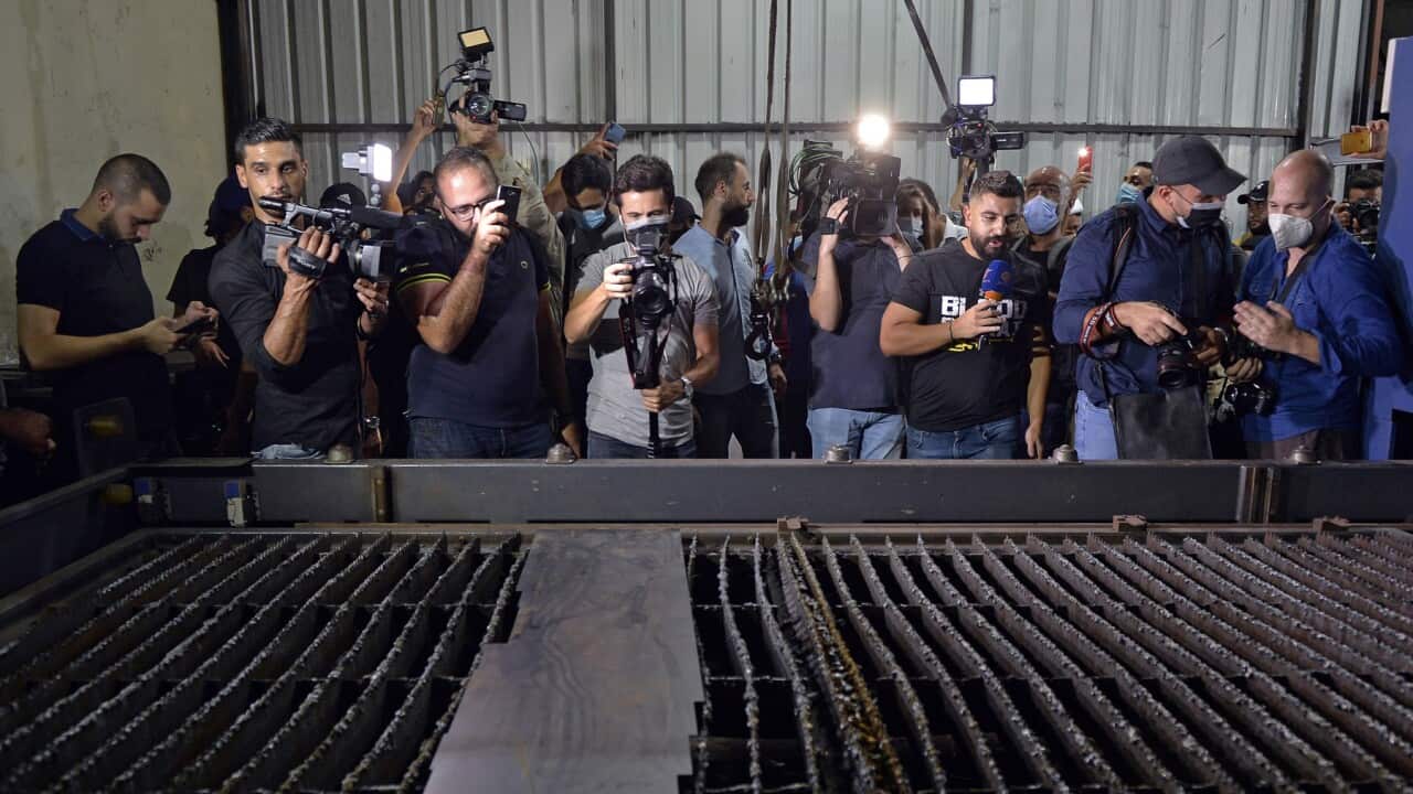 Journalists tour the warehouse that was alleged to be a secret arms depot