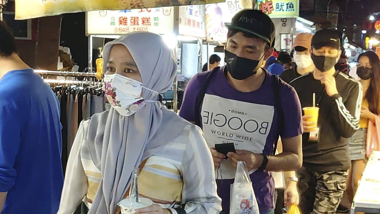 People wear face masks to protect against the spread of the coronavirus at a night market in Taipei, Taiwan, Friday, May 14, 2021. (AP Photo/Chiang Ying-ying)