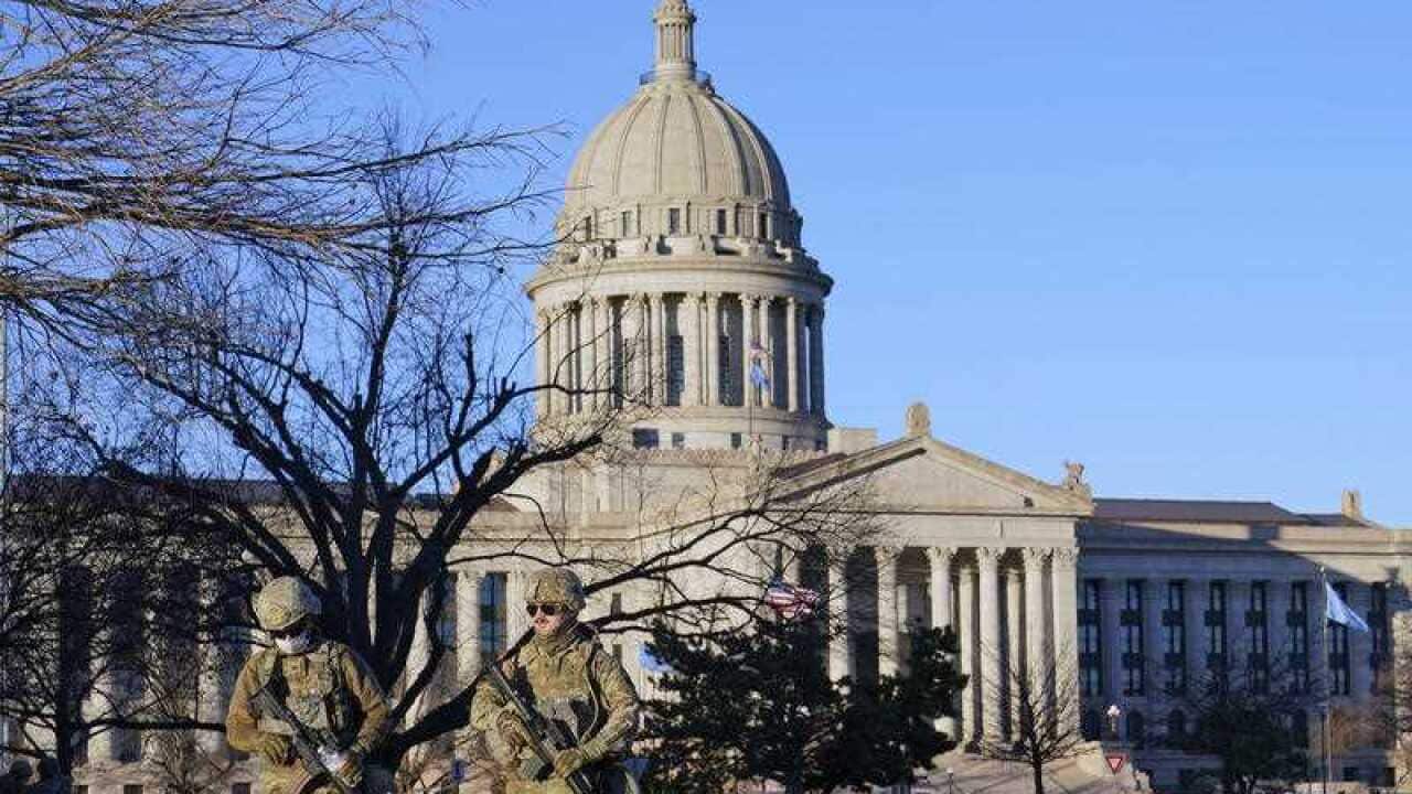 National Guard members patrol the mostly empty grounds near the state Capitol.