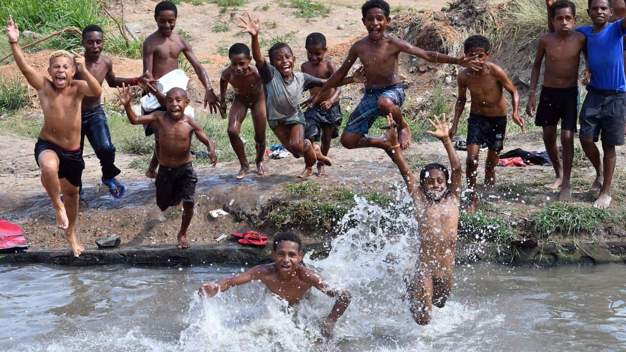 Children jumping in a small pond on the outskirts of Port Moresby, November 19, 2018.