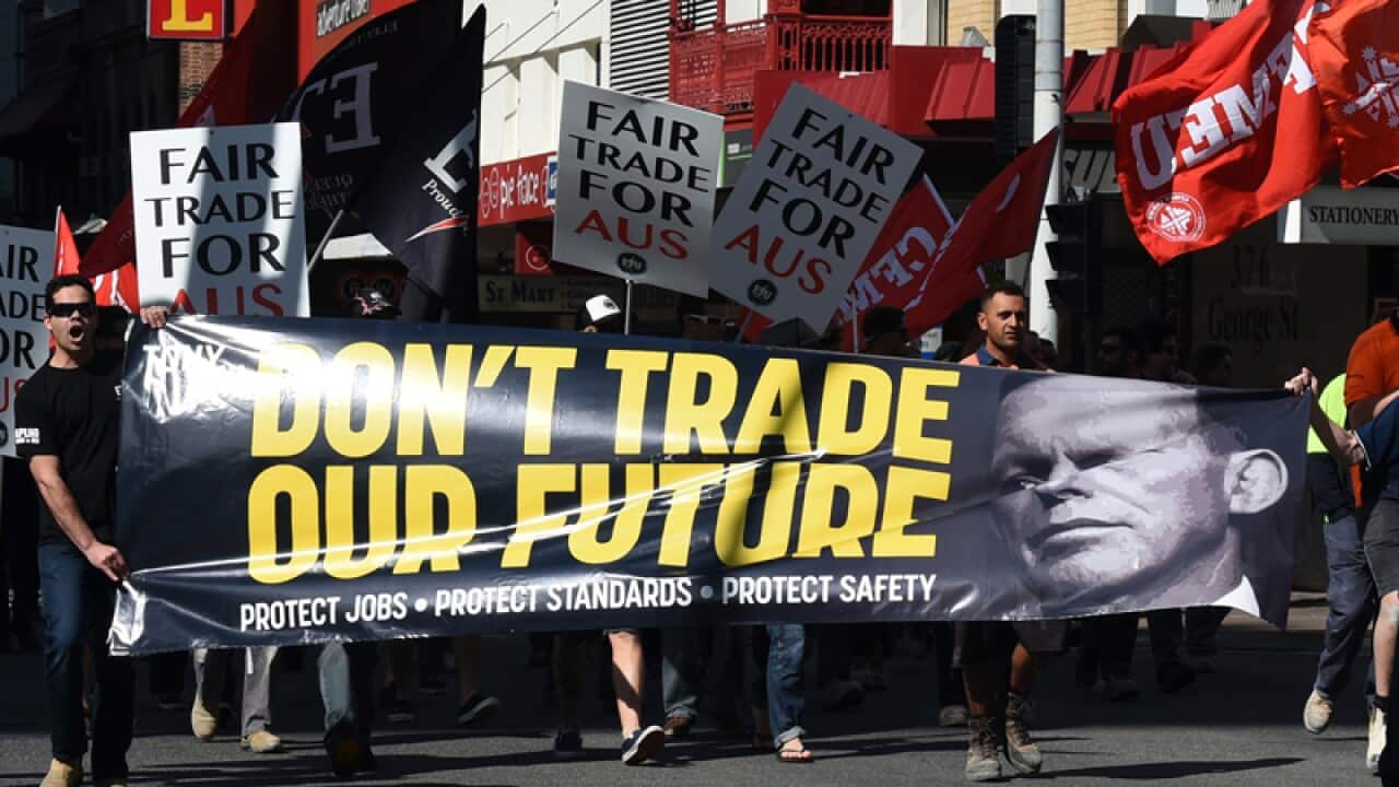 Trade union members protest against the China free trade deal