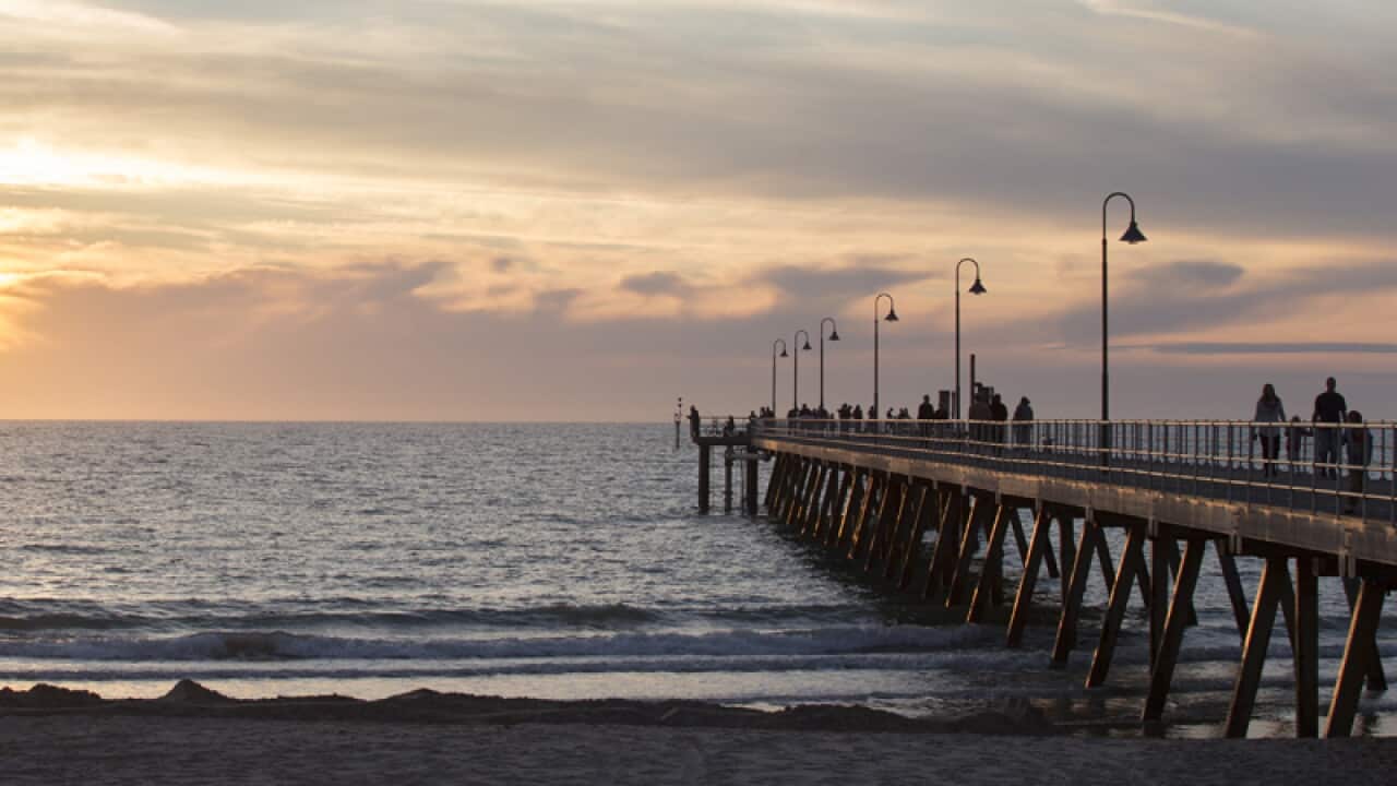 he sun sets over Glenelg Jetty in Adelaide
