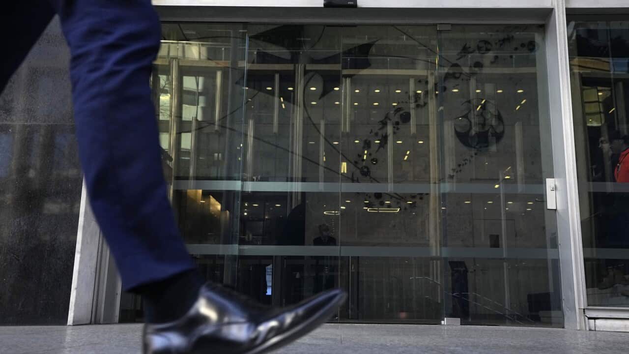 A man walks past the Reserve Bank of Australia in Sydney