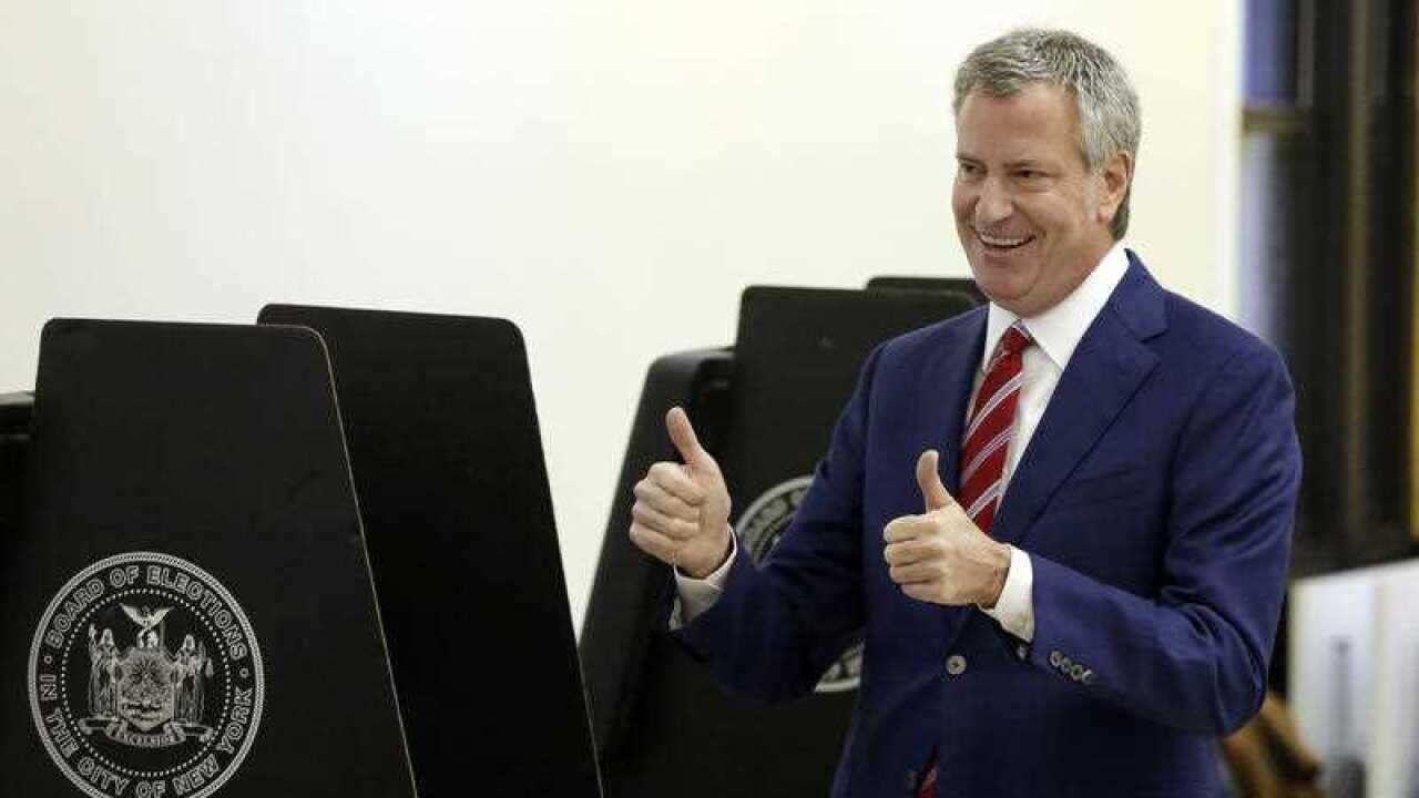 New York Mayor Bill de Blasio signals a double thumbs-up after voting at the Park Slope Library, in the Brooklyn borough of New York, Tuesday, Nov. 7, 2017.