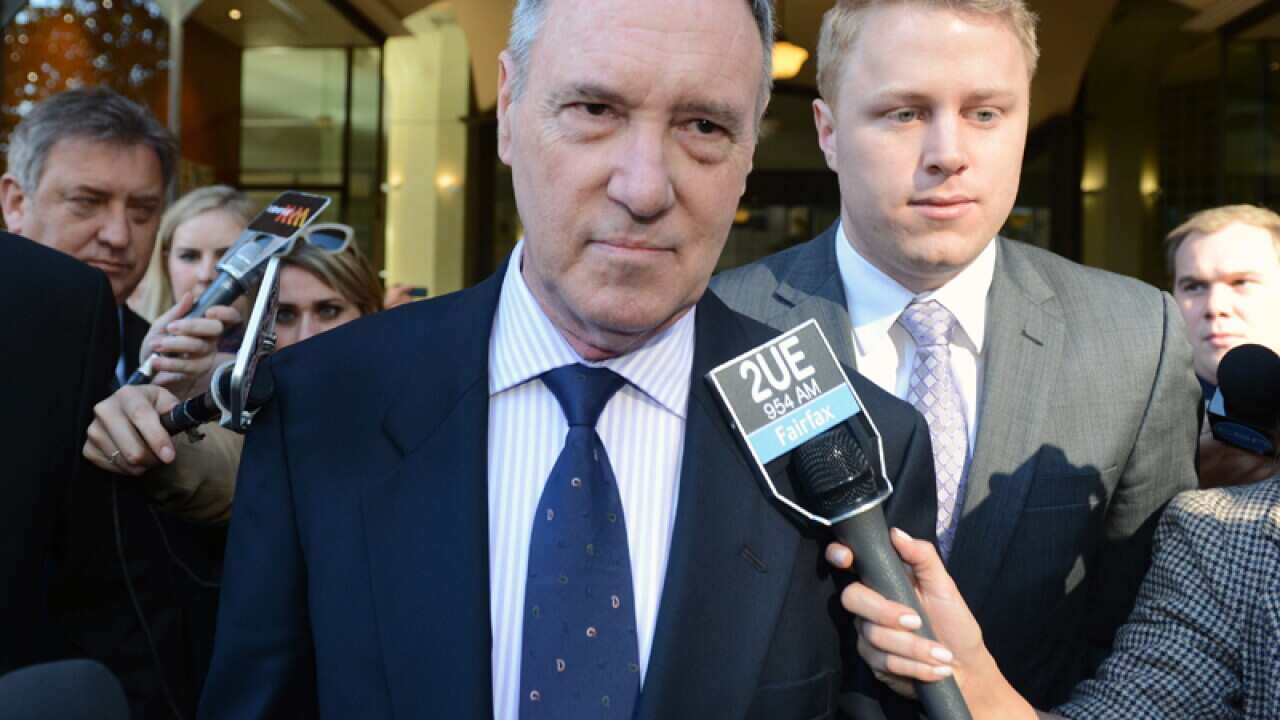 Robert Hughes leaves the Downing Centre Courts in Sydney