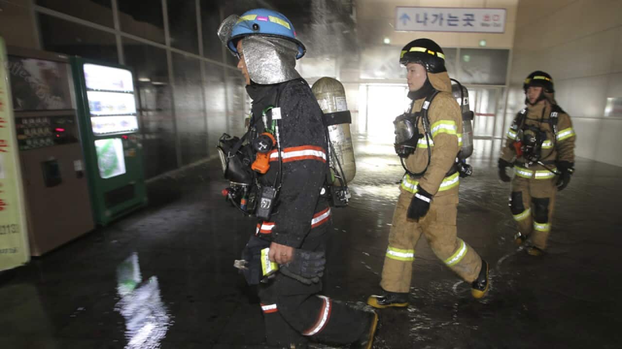 Firefighters arrive at a bus terminal near Seoul