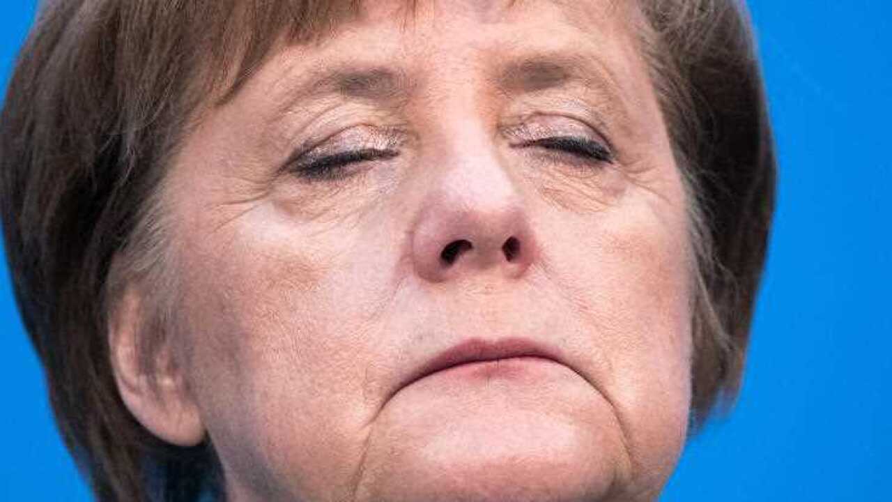 German Chancellor Angela Merkel, of the Christian Democratic Union (CDU) reacts during a press conference with the chairman of the Social Democratic Party