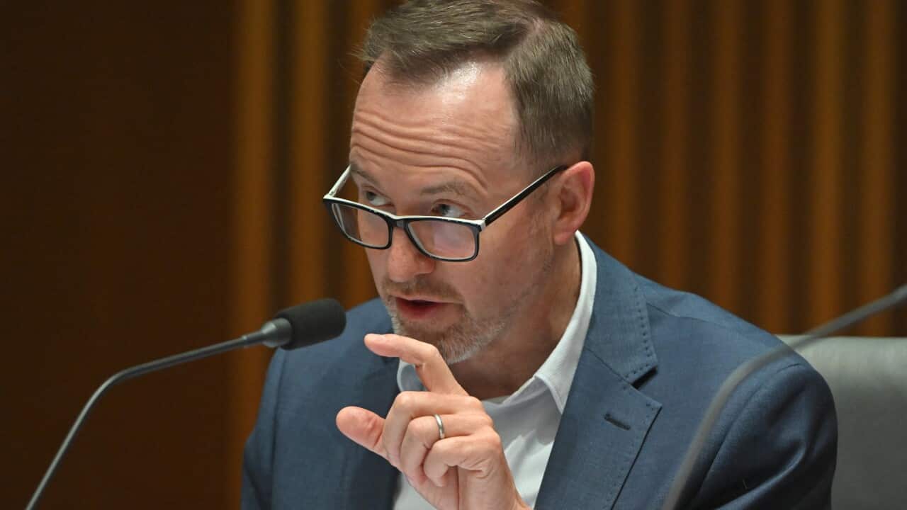 A man in a suit points his finger