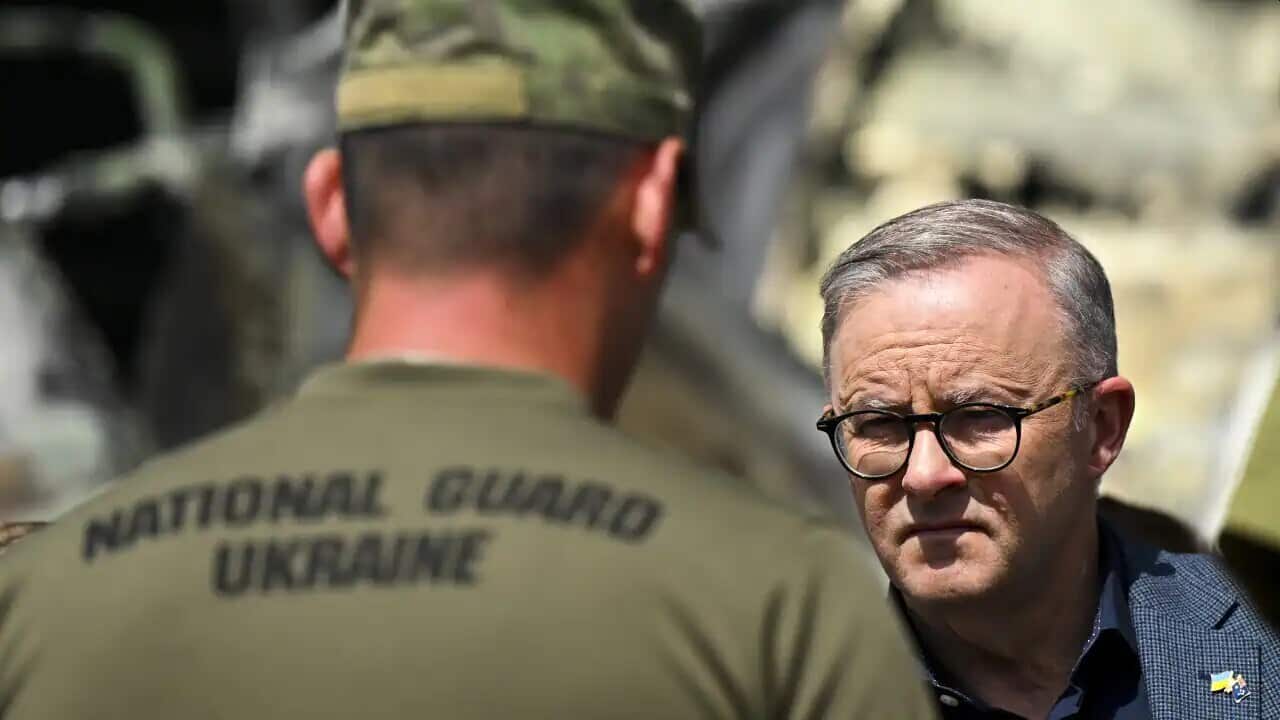 Australian Prime Minister Anthony Albanese speaks to members of the Ukrainian National Guard at Hostomel airport on the outskirts of Kyiv, Ukraine, Sunday, 3 July 2022.