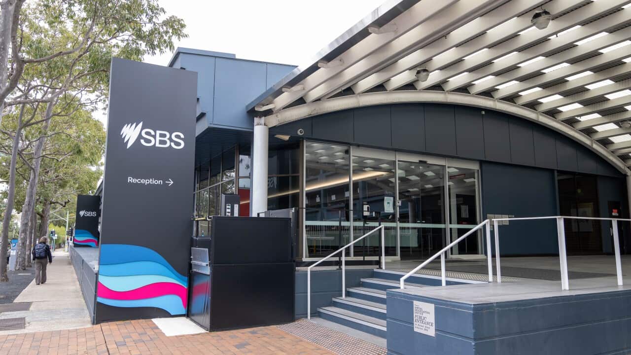 The outside of an office building with a staircase and sign that says 'SBS'.