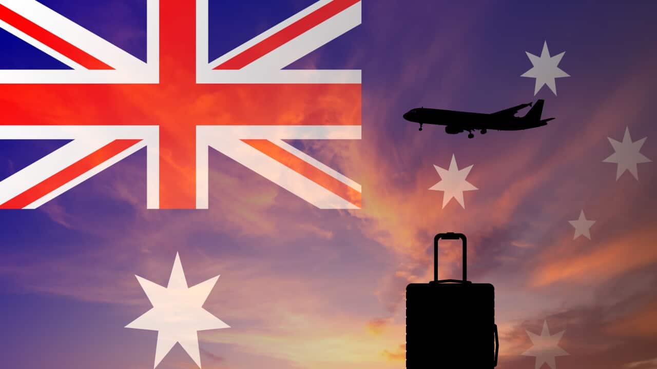 Suitcase and airplane against the background of the Australian flag