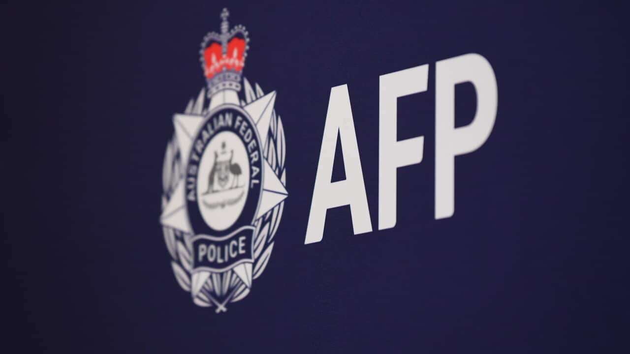Australian Federal Police logo and the letters “AFP” displayed in white on a dark blue backdrop.