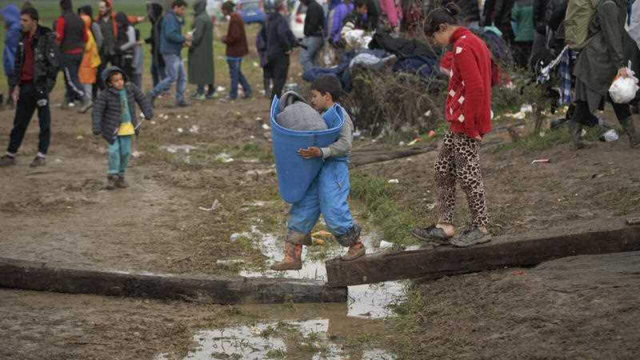 A boy carries blankets at the northern Greek border station of Idomeni.