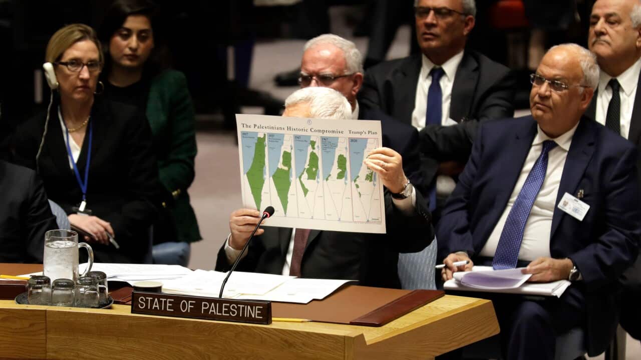 Palestinian President Mahmoud Abbas holds up a map of a 'swiss cheese' Palestinian state