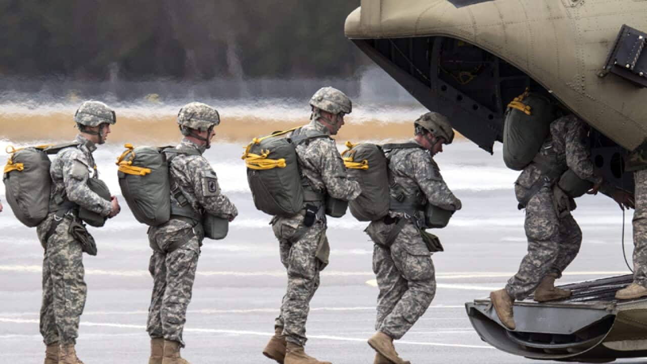 Paratroopers of the US Army enter a helicopter in Germany
