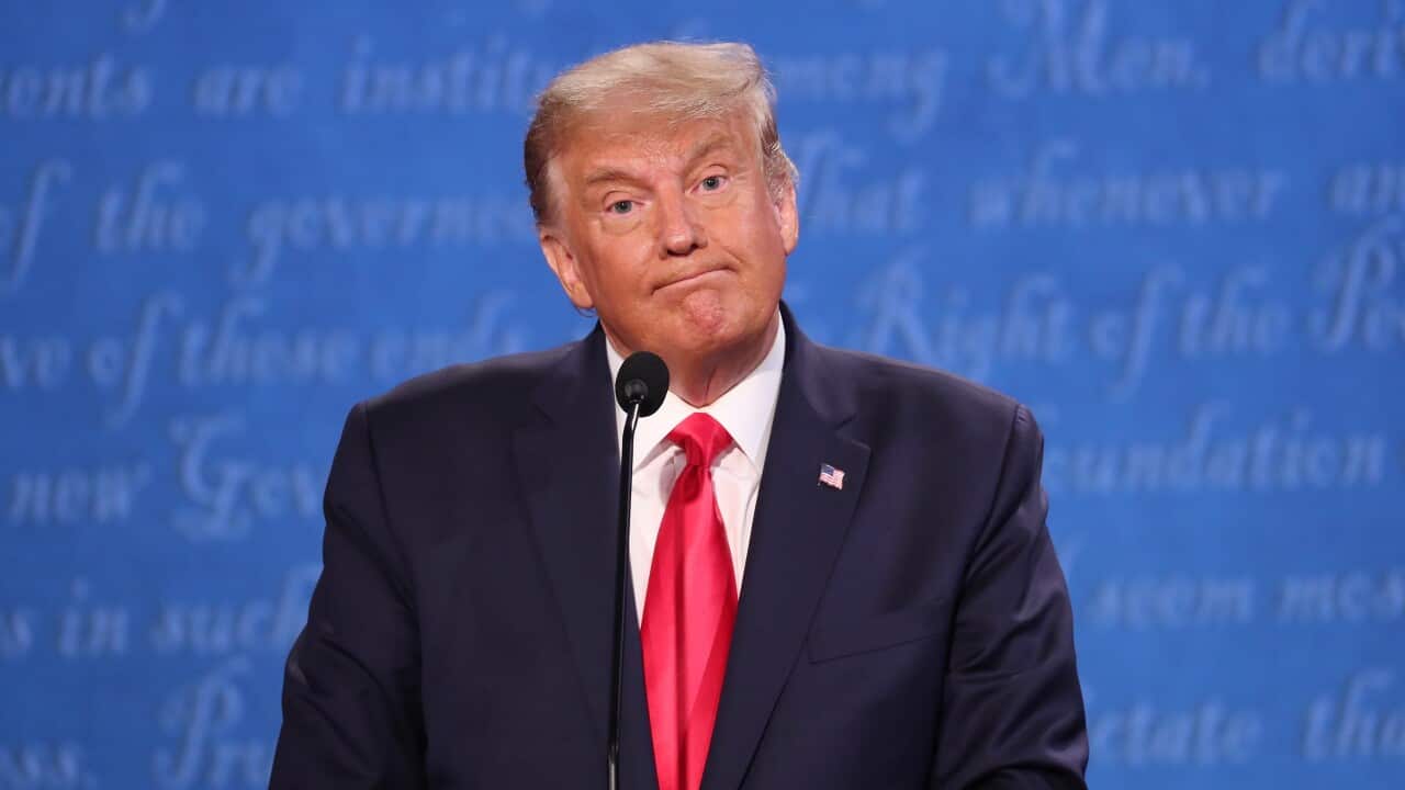 US President Donald J. Trump reacts as he and Democratic candidate Joe Biden participate in the final presidential debate