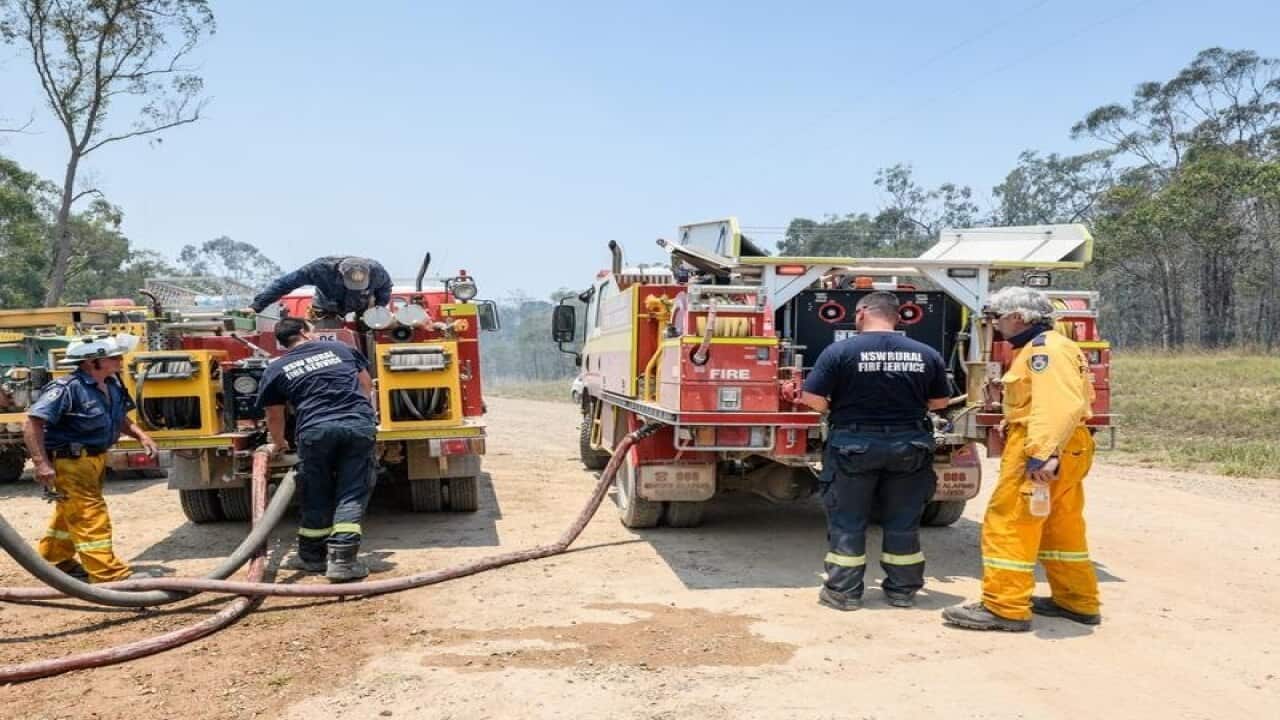 Rural fire fighters refill their fire trucks
