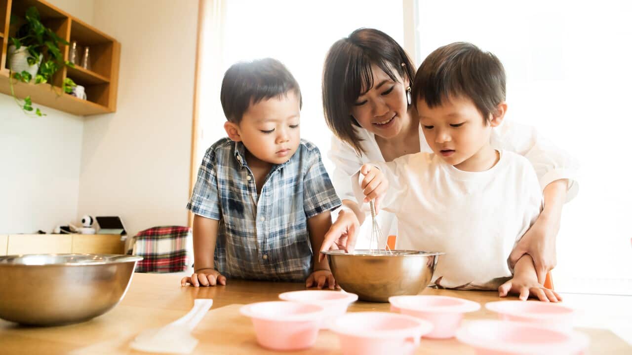 Mother and son cooking together - children cooking with parent