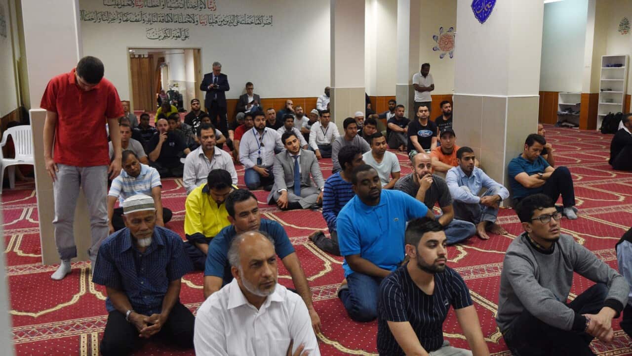 Worshippers listen to Parramatta Mosque chairman Neil El-Kadomi speak at Paramatta Mosque during a Friday prayer meeting, Friday, Oct. 9, 2015. Australia's Muslim community has rejected "deviant so-called religious teachings" in the wake of the murder of