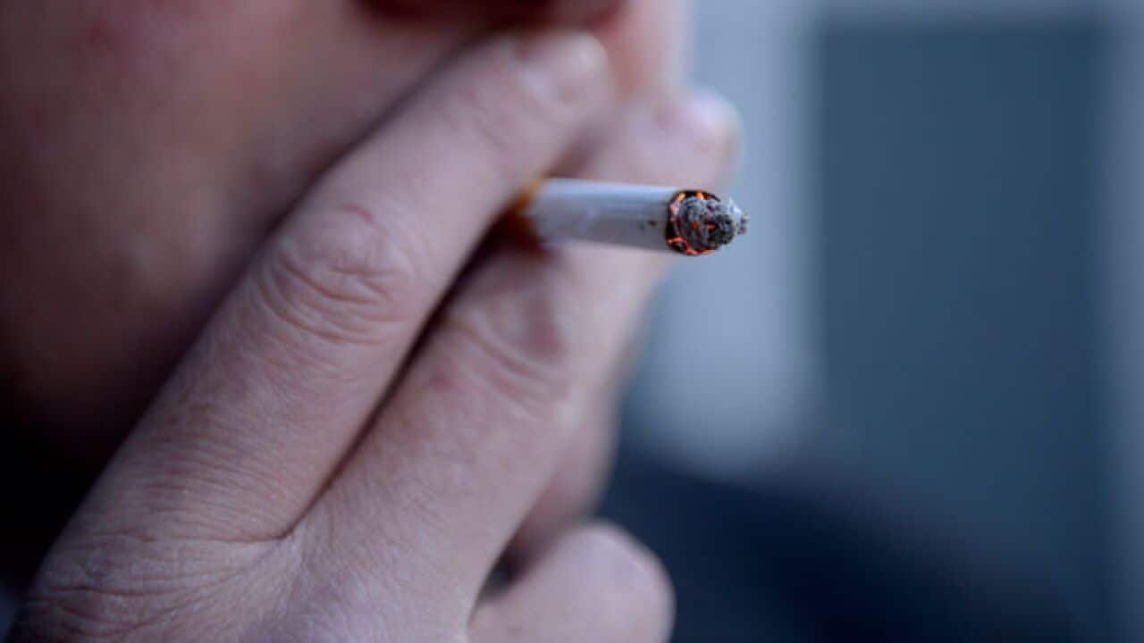 a man smoking a cigarette.