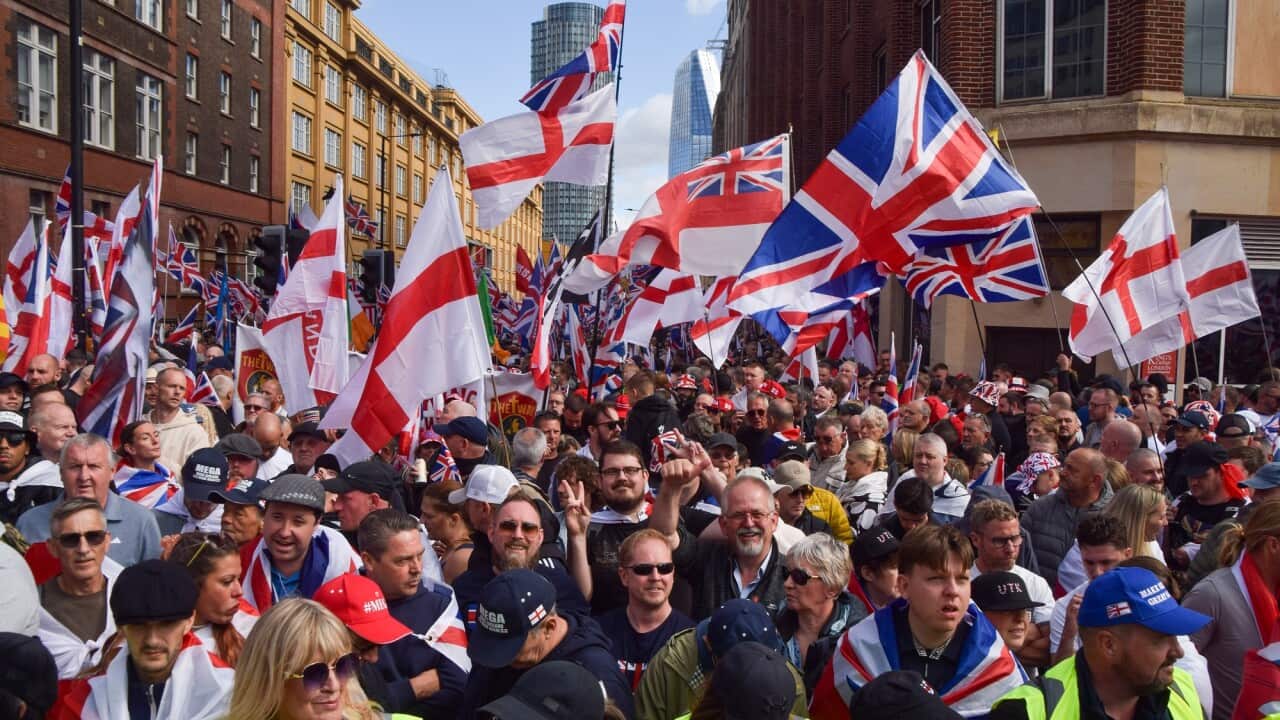 Protesters brandish the national flag of the United Kingdom.