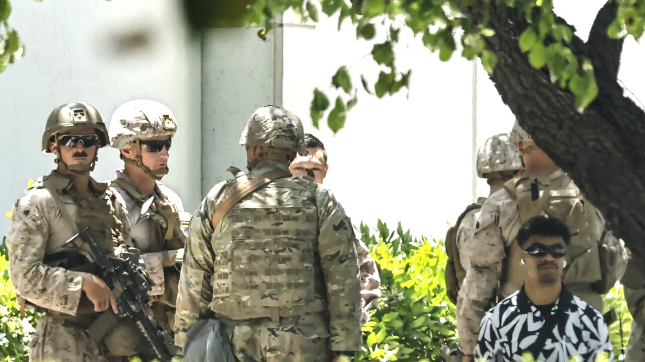 US Marines detain a civilian at Los Angele's Wilshire Federal Building