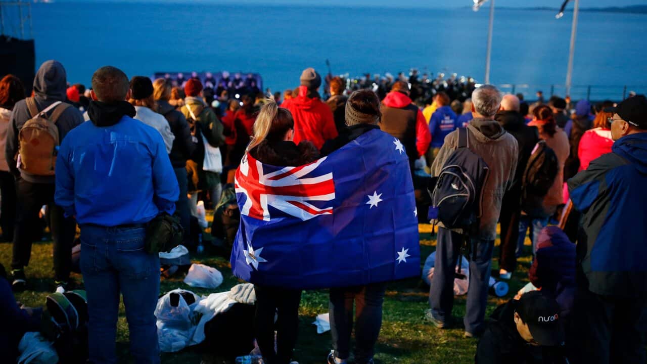 A pair draped with an Australian flag, participate in the Dawn Service ceremony at the Anzac Cove beach in Gallipoli, Turkey.