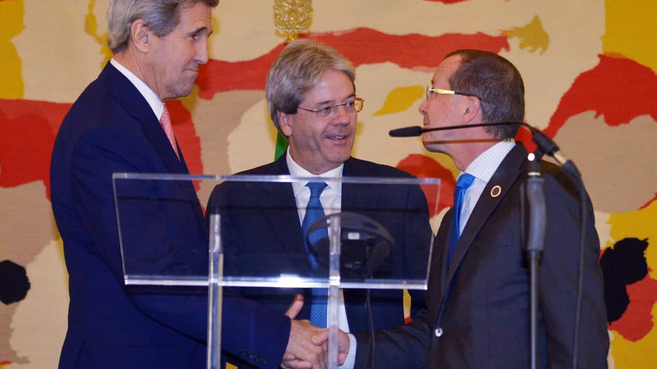 US Secretary of State John Kerry, left, Italian Foreign Minister Paolo Gentiloni, centre, and UN special envoy for Libya Martin Kobler shake hands after their press conference, following an international conference on Libya at the Ministry of Foreign Aff