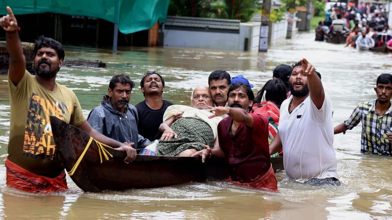 An elderly man is rescued from flood waters in Kochi, Kerala state