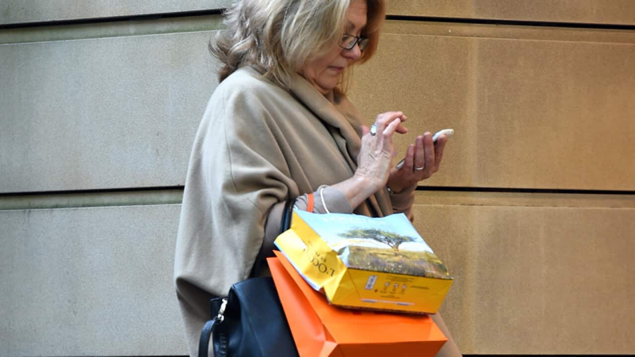 A shopper stands outside of a store in Sydney
