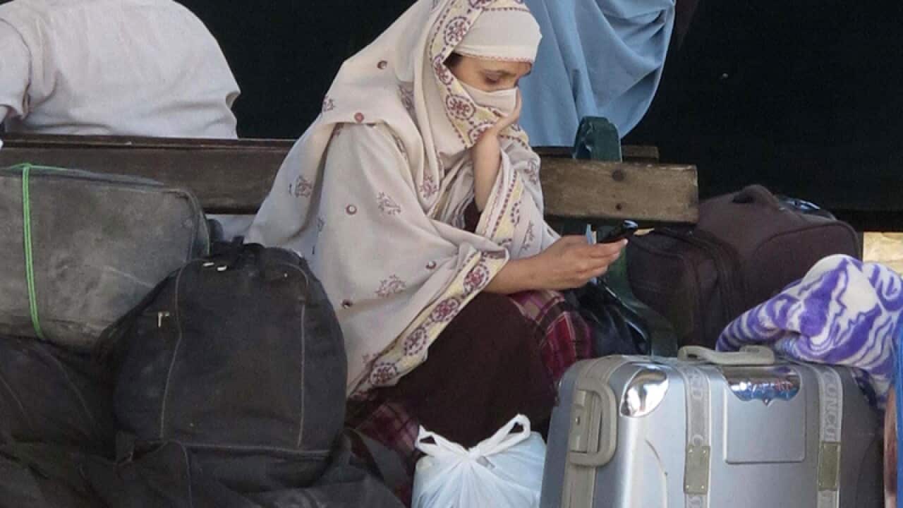 People await their relatives after a suicide bomb blast targeted.