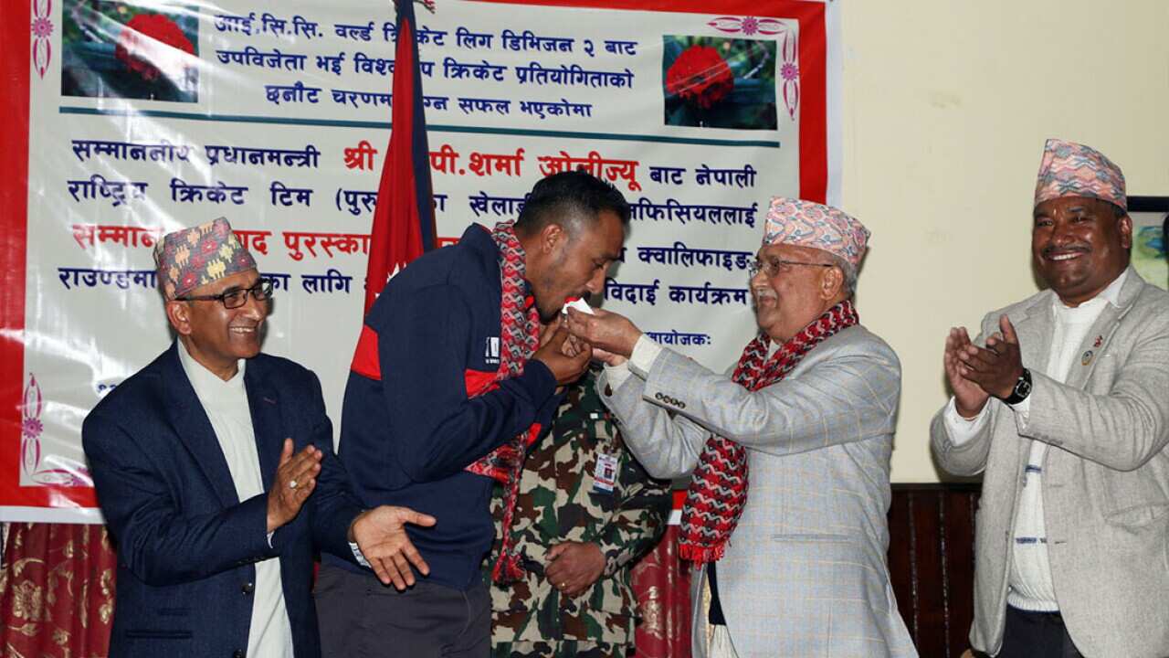 Nepali Cricket captain Paras Khadka eating cake from Prime Minister KP Sharma Oli in Kathmandu in February 2018.