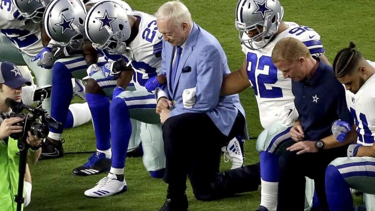 Dallas Cowboys, led by owner Jerry Jones, take a knee