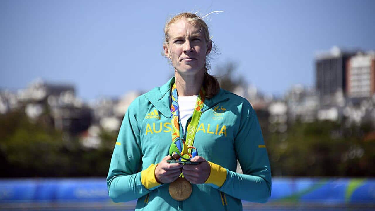 Gold medallist Australia's Kimberley Brennan celebrates on the podium of the Women's Single Sculls