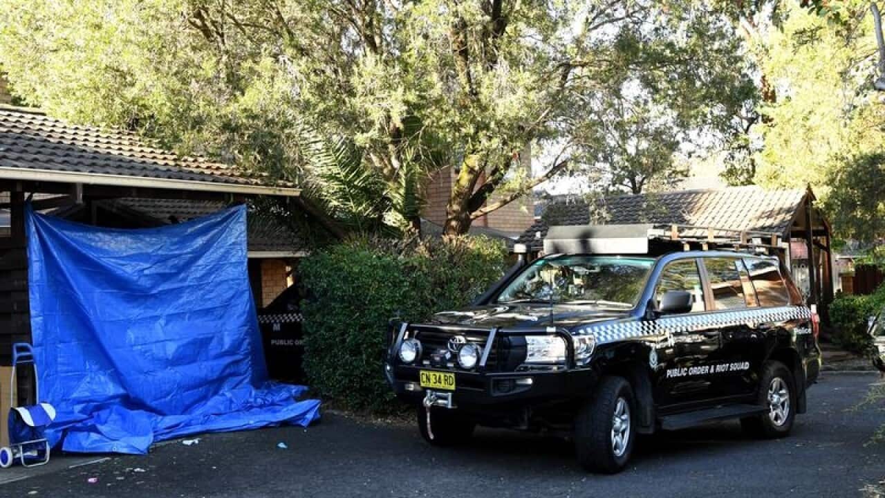 A NSW Police vehicle at a home in Greenacre that was raided.