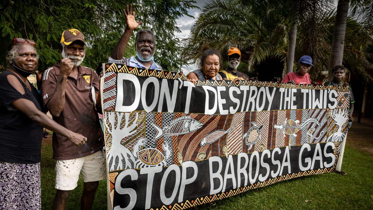 Tiwi Elder Dennis Tipakalippa (waving) launched the legal action against the project in June