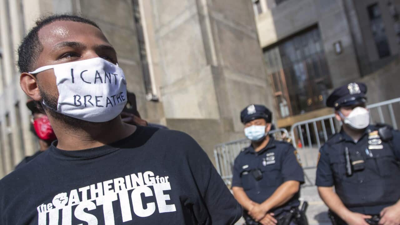 Police and court officers stand guard in front of Manhattan Criminal Court as protesters demonstrate against the the death of George Floyd.
