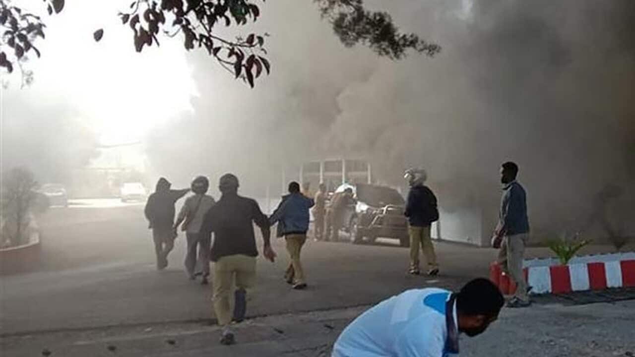 People react as a building burns after fresh protests broke out in Wamena on September 23, 2019.
