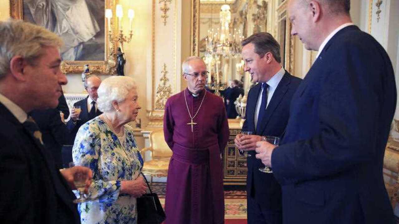 Britain's Queen Elizabeth, second left, speaks with Prime Minister David Cameron, second right, as leader of the House of Commons Chris Grayling, right