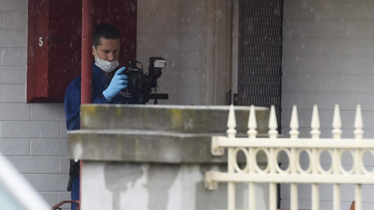 A homicide squad detective outside a residence in Melbourne