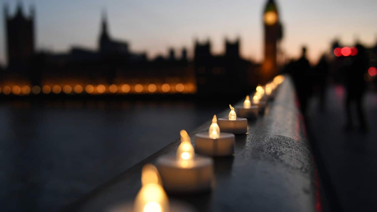 Plastic candles lie along Westminster Bridge in London
