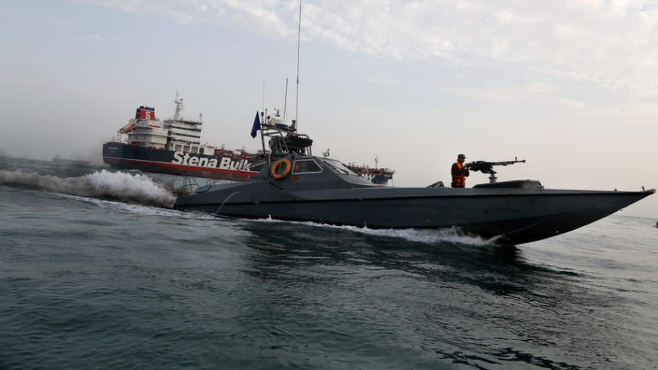 An Iranian Revolutionary Guard boat moves around British-flagged oil tanker Stena Impero in the Iranian port of Bandar Abbas