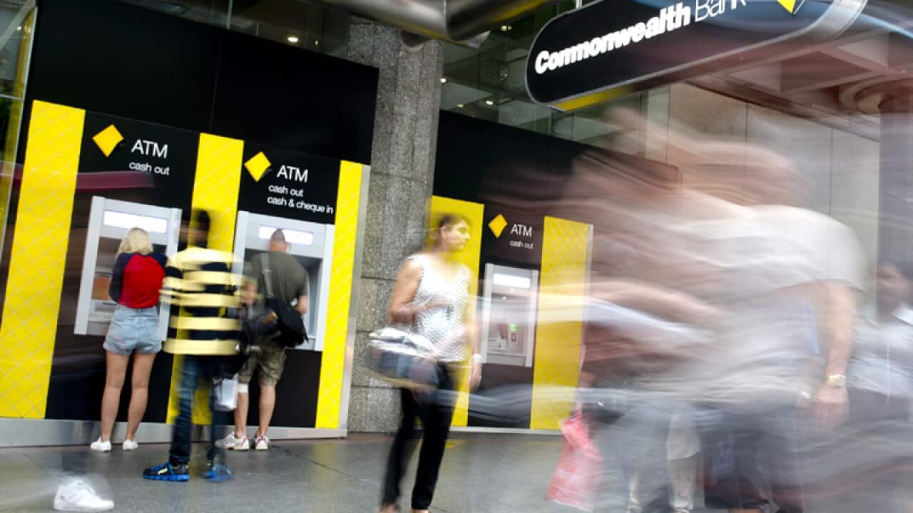 People using ATMs at the Commonwealth Bank