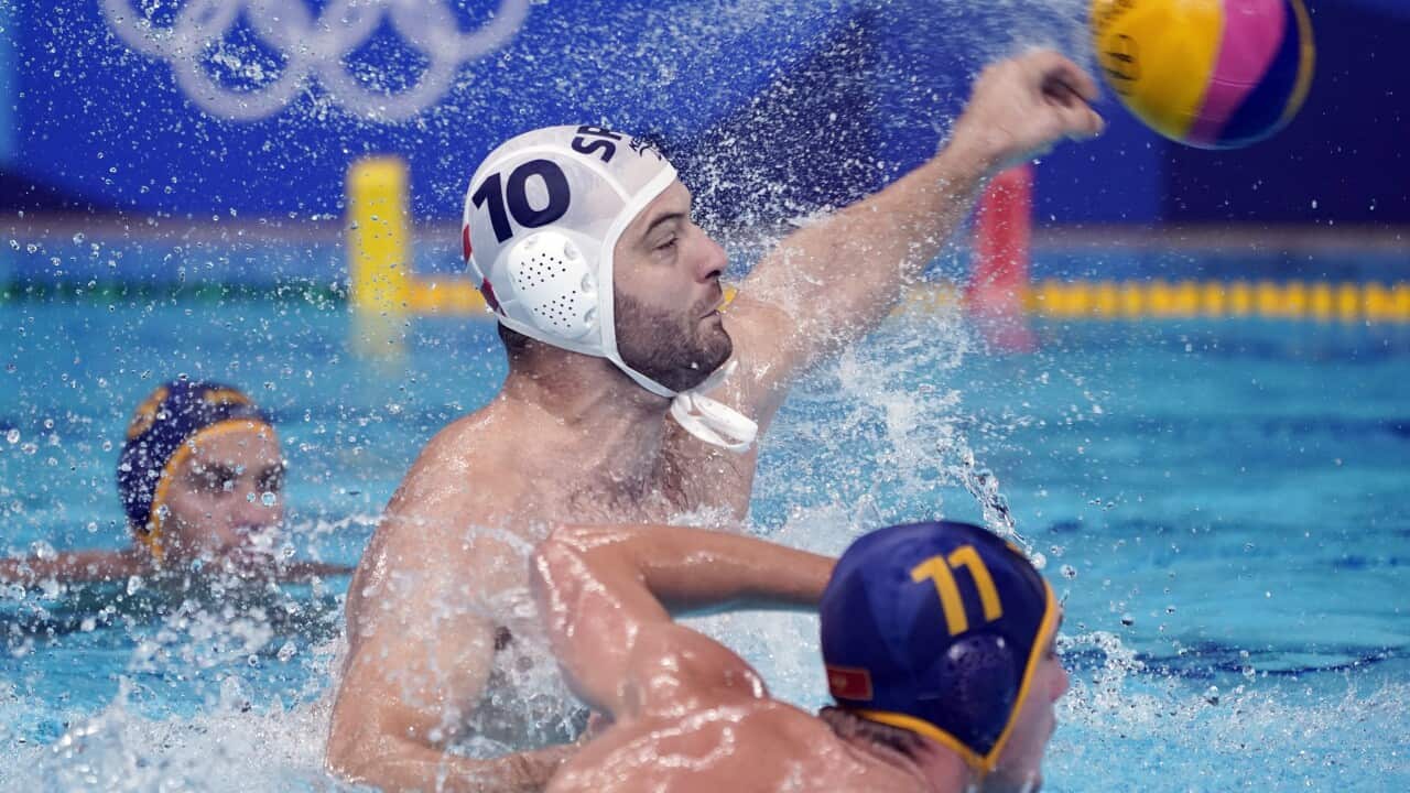 Serbia's Filip Filipovic (10) shoots a penalty shot as Montenegro's Dusan Matkovic (11) watches for the rebound during a preliminary round men's water polo match at the 2020 Summer Olympics, Monday, Aug. 2, 2021, in Tokyo, Japan. (AP Photo/Mark Humphrey)
