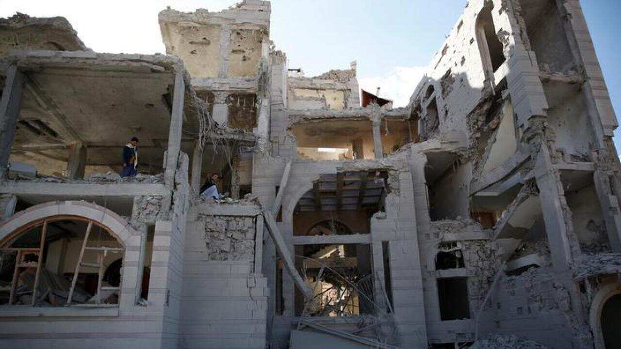 Men inspect a house destroyed by Saudi-led airstrikes in Sana’a, Yemen