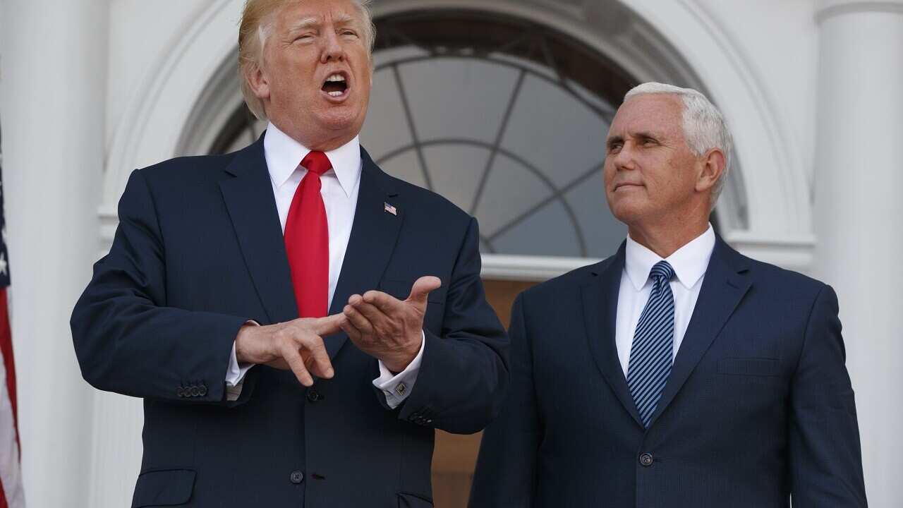 Vice President Mike Pence listens as President Donald Trump speaks to reporters at Trump National Golf Club, Bedminster, Aug. 10, 2017.