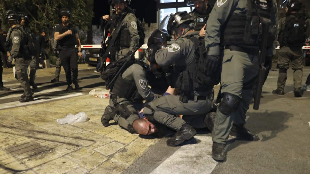 Israeli border police officers detain a Palestinian demonstrator during clashes with Palestinian protesters, in east Jerusalem, Friday, May 7. 2021.