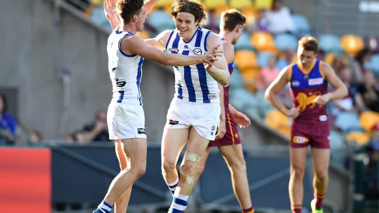 Ben Brown of the Kangaroos celebrates scoring a goal against Brisbane