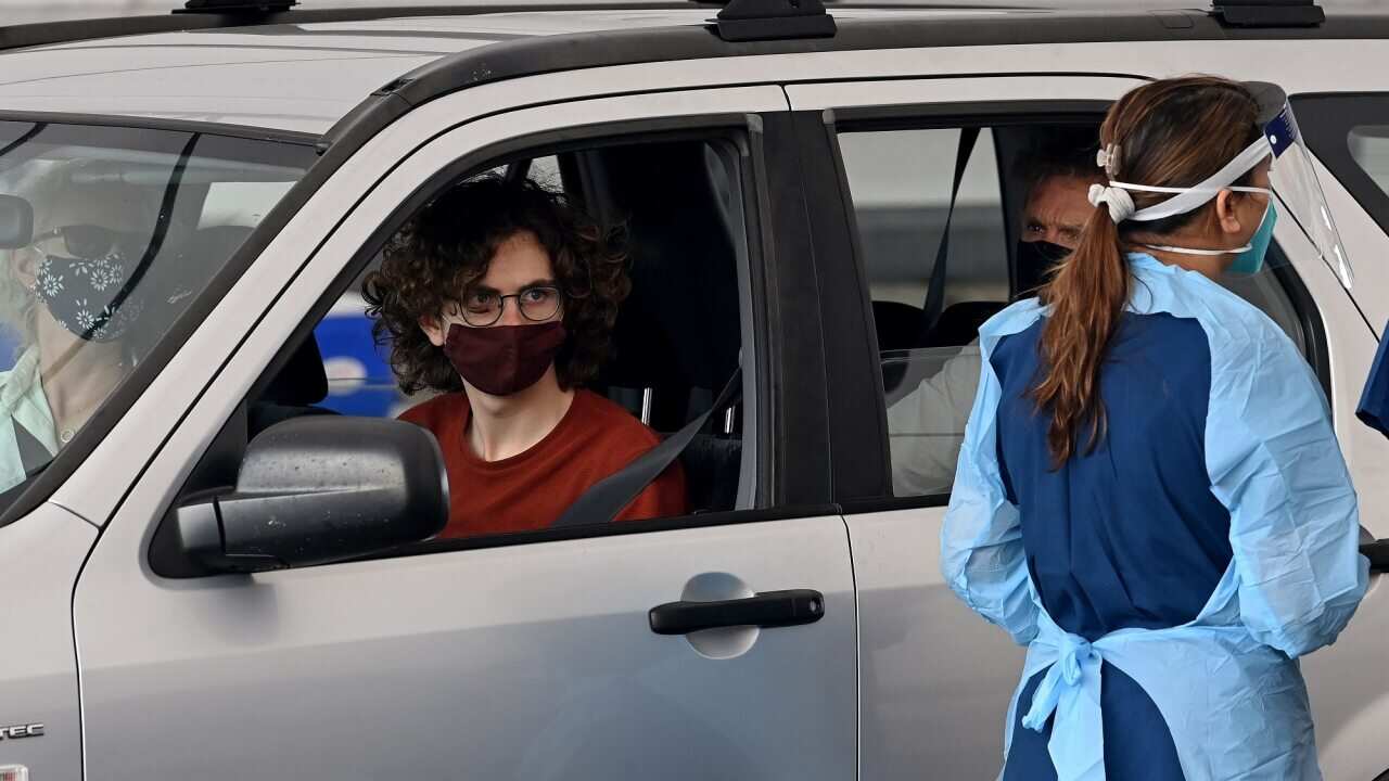 Members of the public queue in their cars for a COVID-19 PCR test in Sydney.
