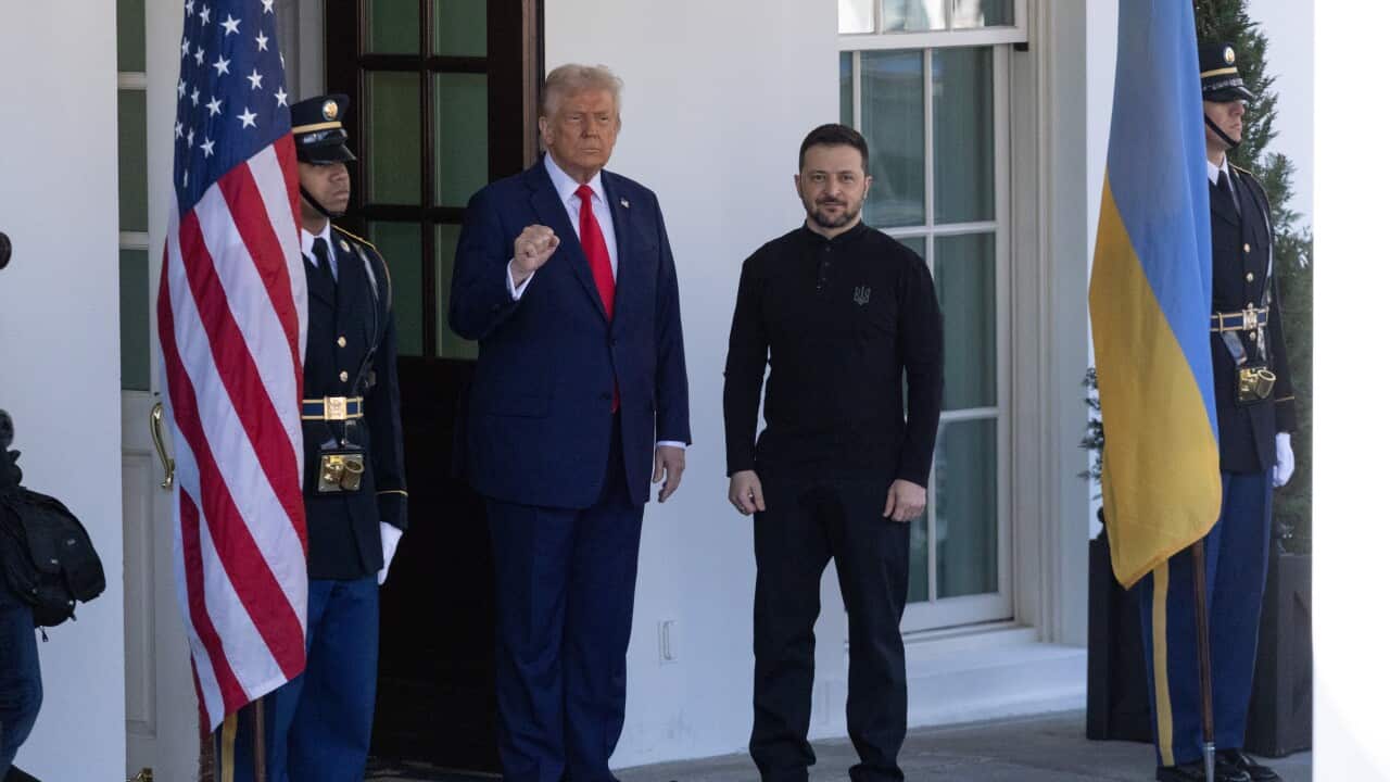 Donald Trump and Volodomyr Zelenskyy standing outside a white building.